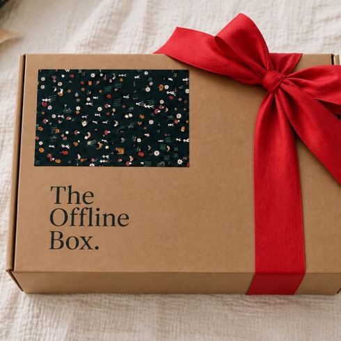The Offline Box, Christmas Edition: a kraft gift box with a hand-printed lid and a red silk bow
